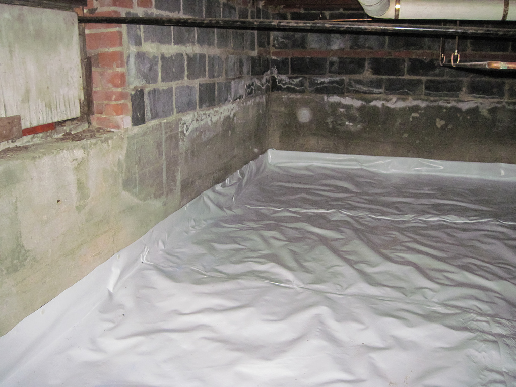Basement floor with a waterproof tarp on the floor