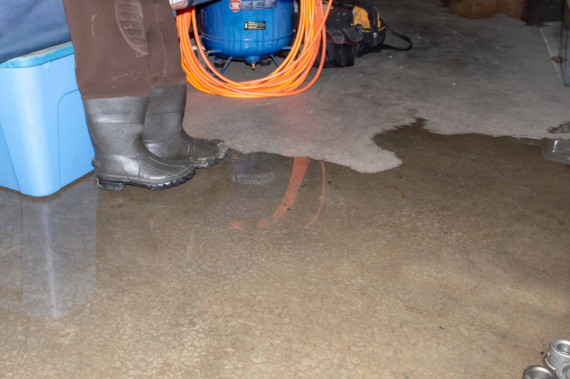 Flooded basement, close up shot of rubber boots