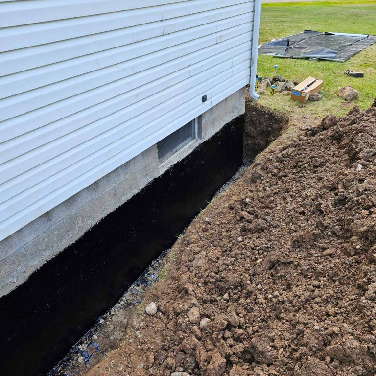 Trench dug along home foundation to begin foundation repairs