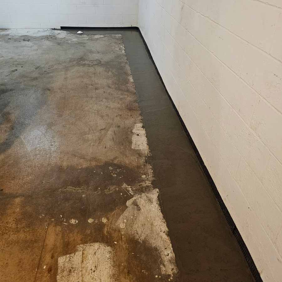 Waterproof barrier installed around edge of basement